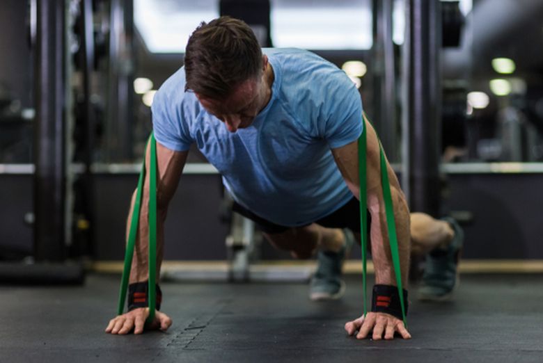 Athlete performing a resistance-band push-up